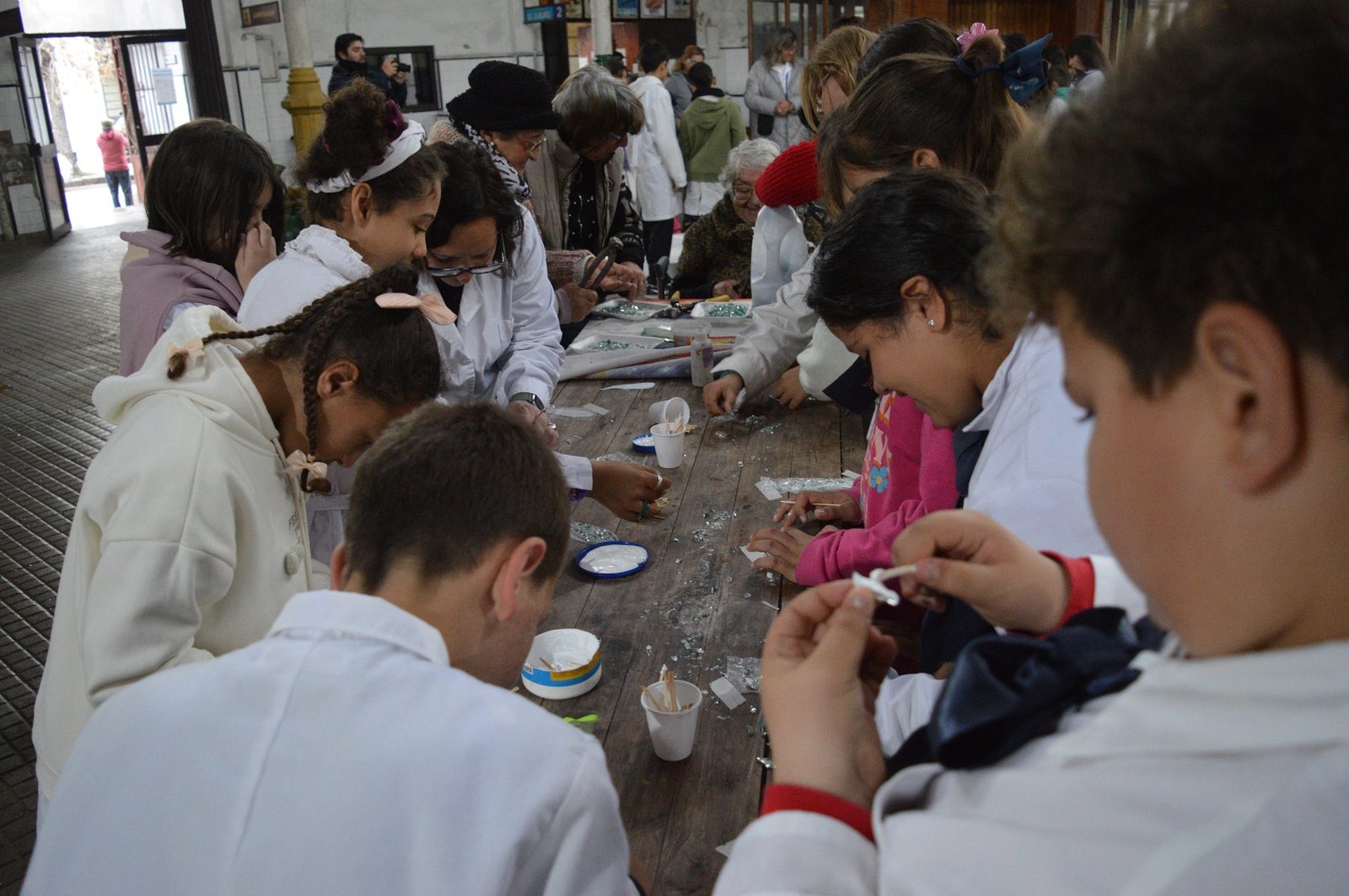Escolares cortando/seleccionando teselas para el mosaico